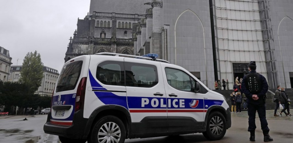French police officers stand guard outside Notre Dame church in Lille, northern France, Sunday, Nov. 1, 2020. France heightened its security alert amid religious and geopolitical tensions around cartoons mocking the Muslim prophet. (AP Photo/Michel Spingler)