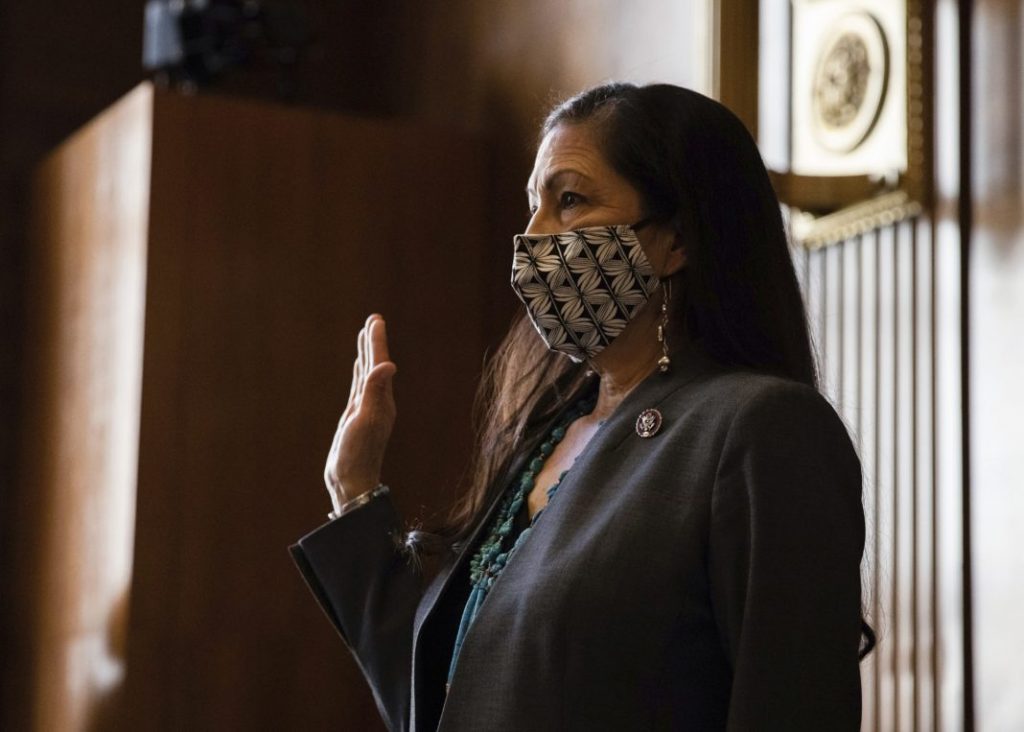 FILE - In this Feb. 23, 2021, file photo, Rep. Deb Haaland, D-N.M., is sworn in during a Senate Committee on Energy and Natural Resources hearing on her nomination to be Interior Secretary, on Capitol Hill in Washington. The Senate has confirmed New Mexico Rep. Deb Haaland as interior secretary, making her the first Native American to lead a Cabinet department and the first to lead the federal agency that has wielded influence over the nation's tribes for nearly two centuries. Democrats and tribal groups hailed Haaland's confirmation as historic. For the first time a Native American will lead the powerful department where decisions on relations with the nearly 600 federally recognized tribes are made. Interior also oversees a host of other issues, including energy development on public lands and waters, national parks and endangered species. (Graeme Jennings/Pool via AP, File)