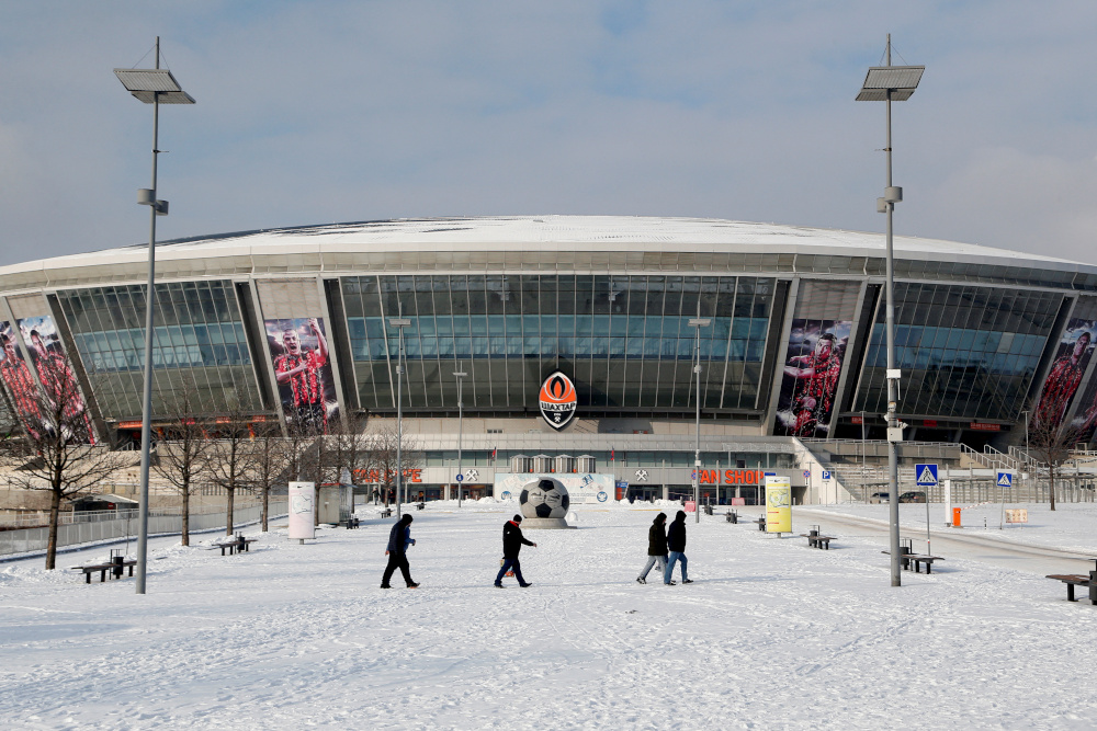 People walk near the Donbass Arena stadium in the rebel-held city of Donetsk, Ukraine January 27, 2022. REUTERS/Alexander Ermochenko