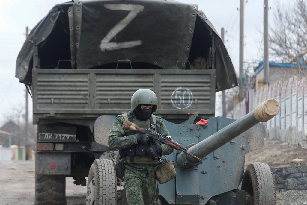 A service member of pro-Russian troops in a uniform without insignia walks past a truck with the letter "Z" painted on its tent top in the separatist-controlled settlement of Buhas (Bugas), as Russia's invasion of Ukraine continues, in the Donetsk region, Ukraine March 1, 2022. REUTERS/Alexander Ermochenko
