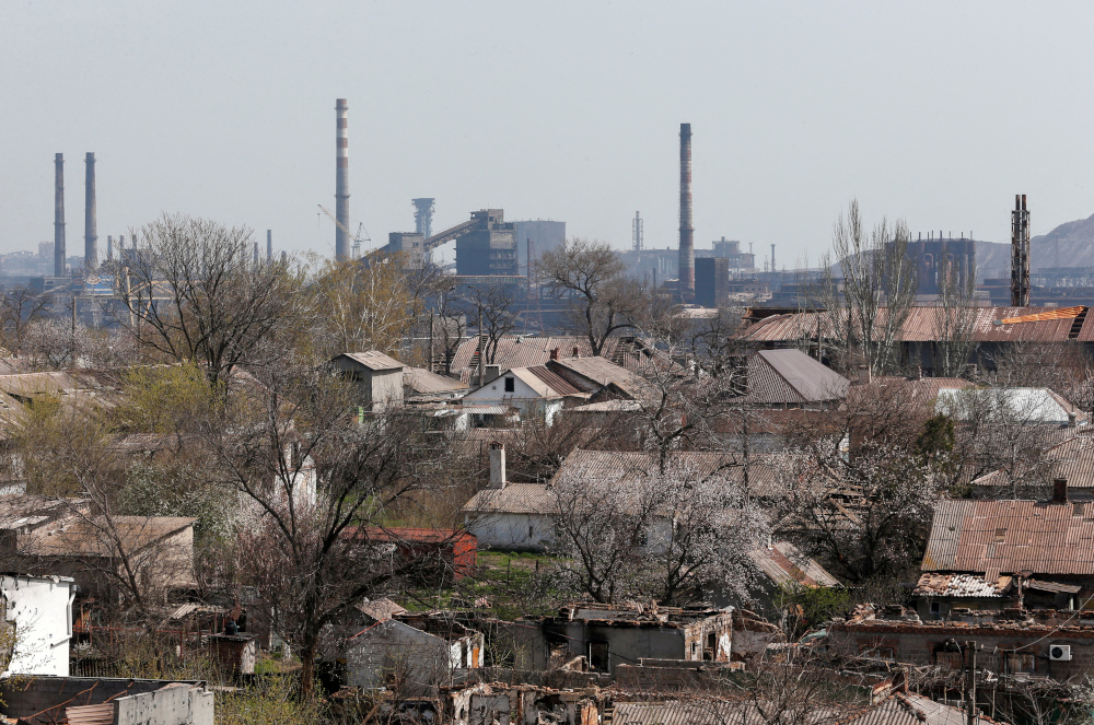 FILE PHOTO: A view shows a plant of Azovstal Iron and Steel Works company behind buildings damaged in the course of Ukraine-Russia conflict in the southern port city of Mariupol, Ukraine April 18, 2022. REUTERS/Alexander Ermochenko/File Photo