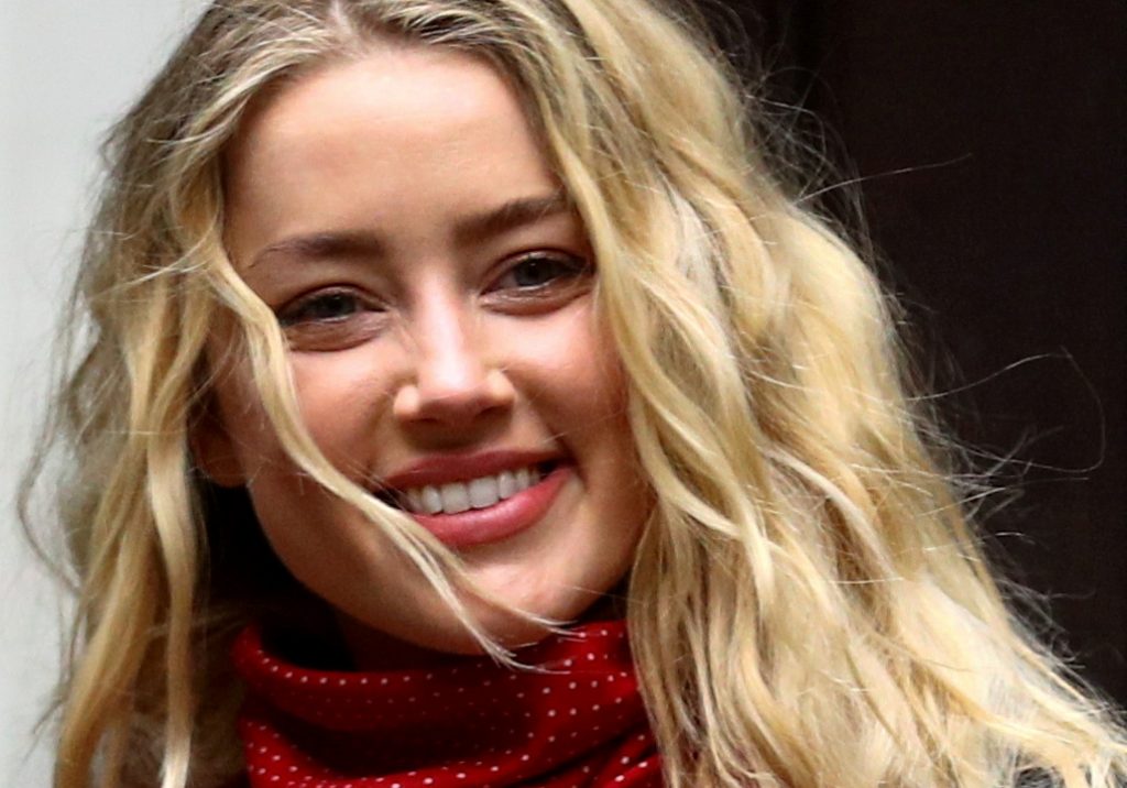 FILE PHOTO: Actor Amber Heard reacts as she arrives at the High Court in London, Britain July 16, 2020. REUTERS/Hannah McKay