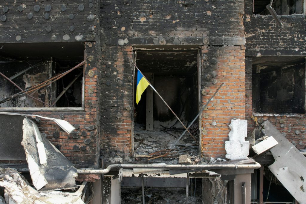 A Ukrainian national flag is seen in an apartment of a residential building damaged during Russia?s invasion of Ukraine in the town of Irpin, outside Kyiv, Ukraine April 29, 2022. Picture taken with a drone. REUTERS/Valentyn Ogirenko