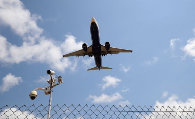 A Ryanair airplane passes a security camera as it lands at Barcelona-El Prat airport, the day before a cabin crew strike is to be held in European countries, in Barcelona, Spain, July 24, 2018. REUTERS/Albert Gea