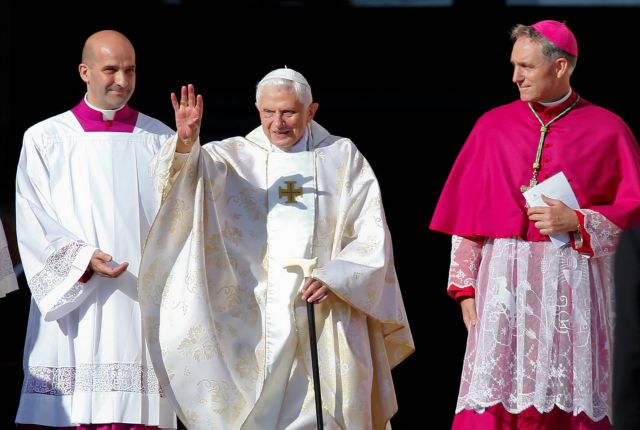 FILE PHOTO: Emeritus Pope Benedict XVI waves as he arrives to attend a mass for the beatification of former pope Paul VI in St. Peter's square at the Vatican October 19, 2014. REUTERS/Tony Gentile/File Photo